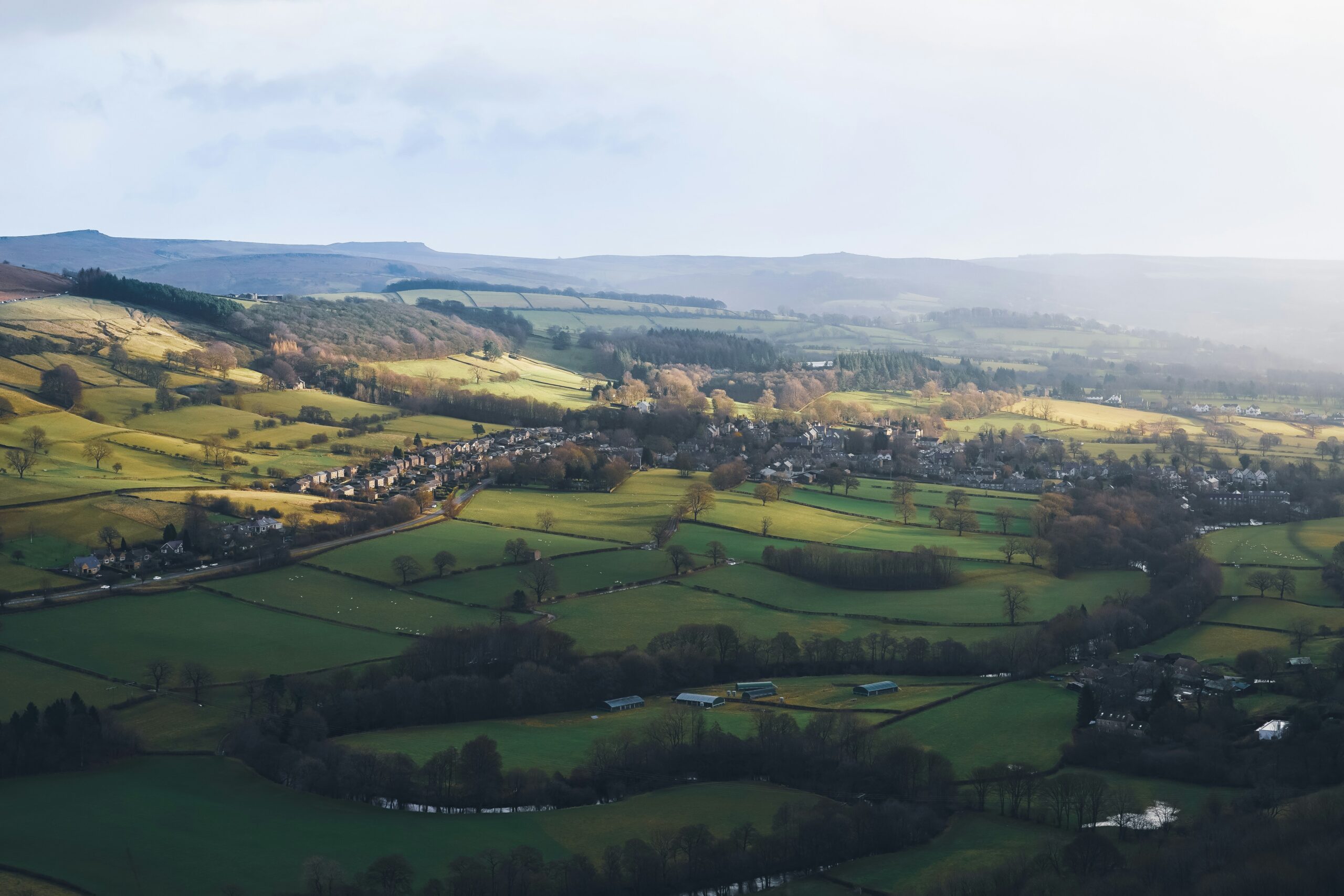 Aerial view of fields beside a small countryside settlement