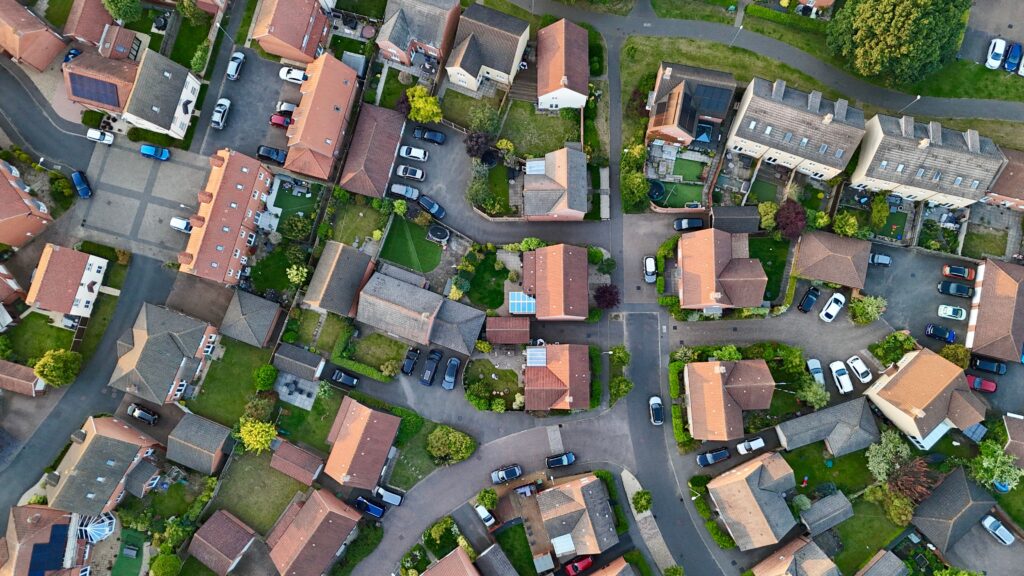 Placemaking in new housing shown through homes, connected streets, trees and green space in Cringleford, England